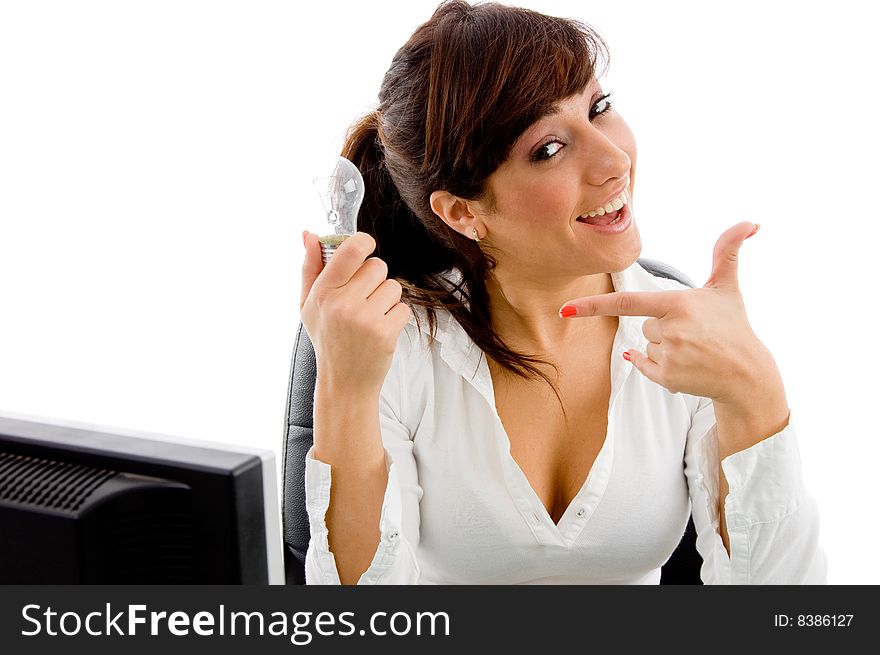 Portrait of smiling woman indicating receiver against white background