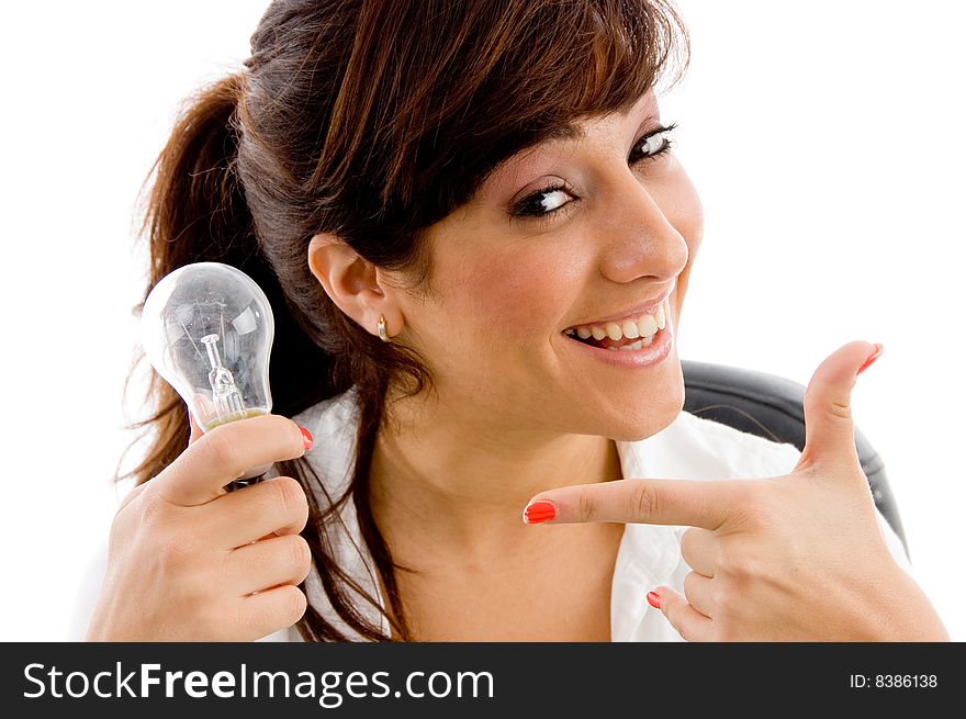 Portrait of smiling woman indicating bulb on an isolated white background