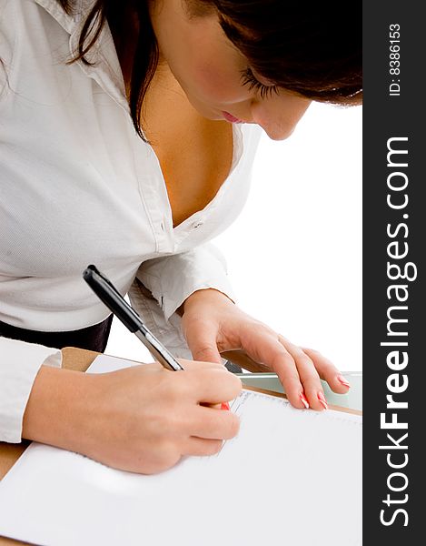 Side pose of businesswoman signing the papers with white background