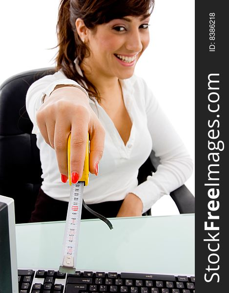 Front view of smiling woman showing measurement tape on an isolated background