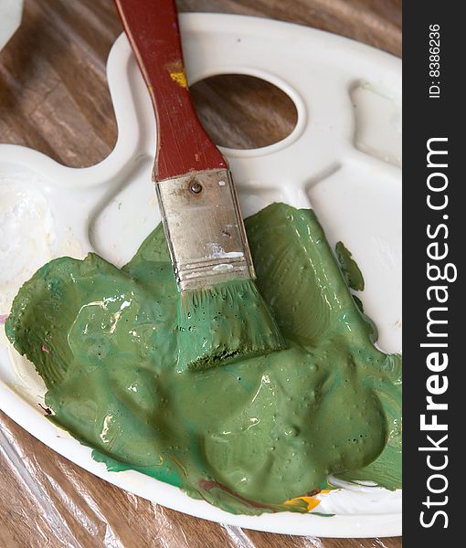 Artist brush with green paint