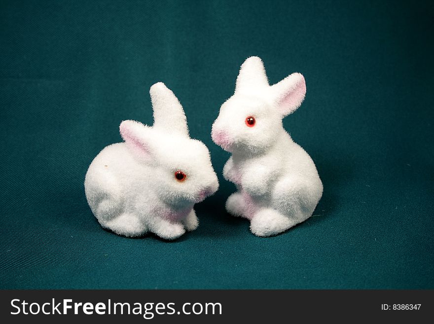 White rabbits on the dark background as Easter symbol