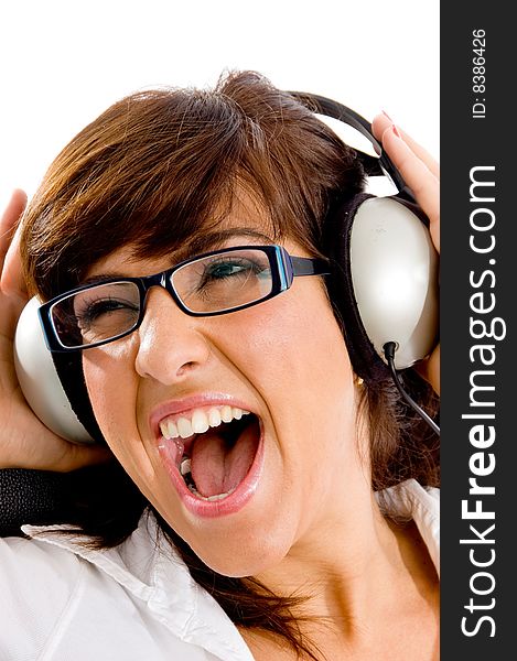 Close view of shouting woman listening music on an isolated white background