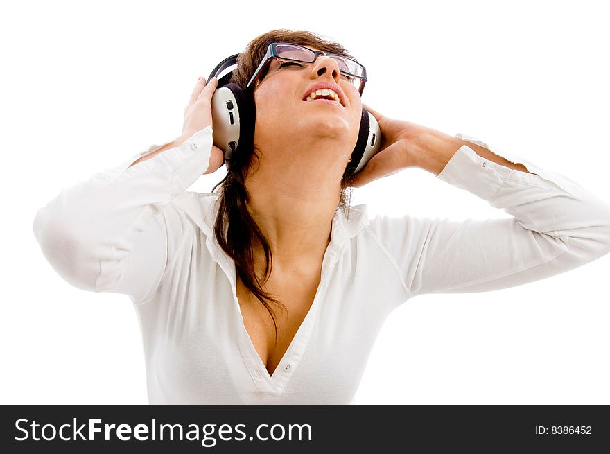 Portrait of young female listening music on an isolated white background