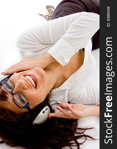 Top view of smiling woman listening music against white background