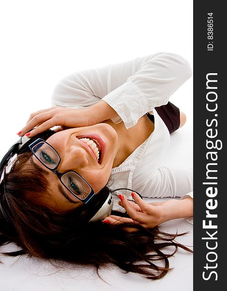 Top view of smiling female enjoying music on an isolated white background