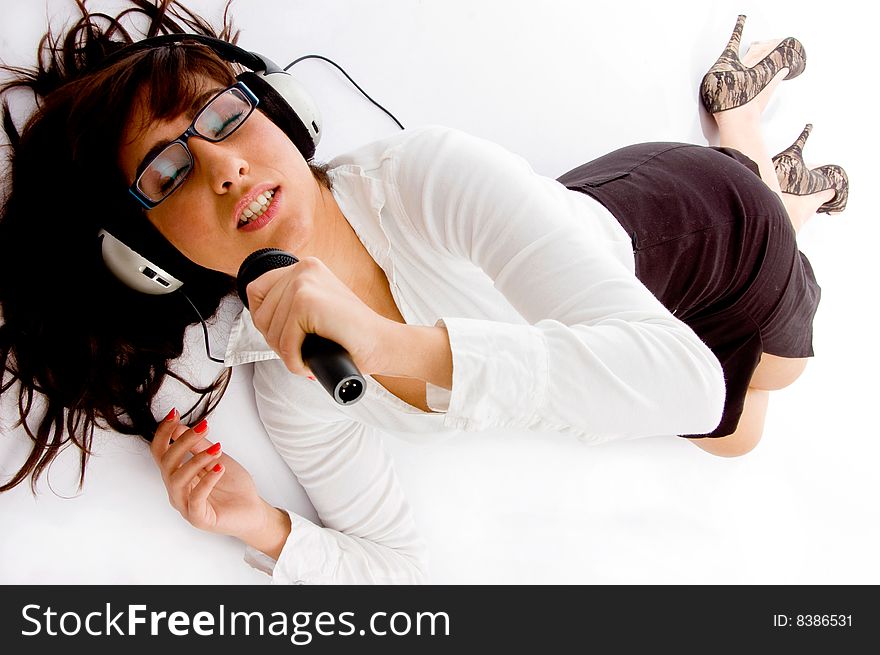 Top view of singing woman listening music on an isolated white background