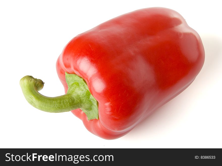 There is a red  sweet pepper on the white background. There is a red  sweet pepper on the white background