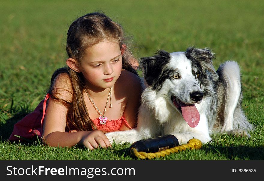 Girl and her dog having a rest after playing. Girl and her dog having a rest after playing