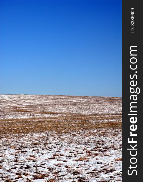 A snow and ice covered field with a clear blue sky. A snow and ice covered field with a clear blue sky.