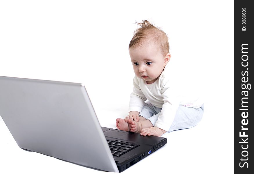 Little baby with laptop on white