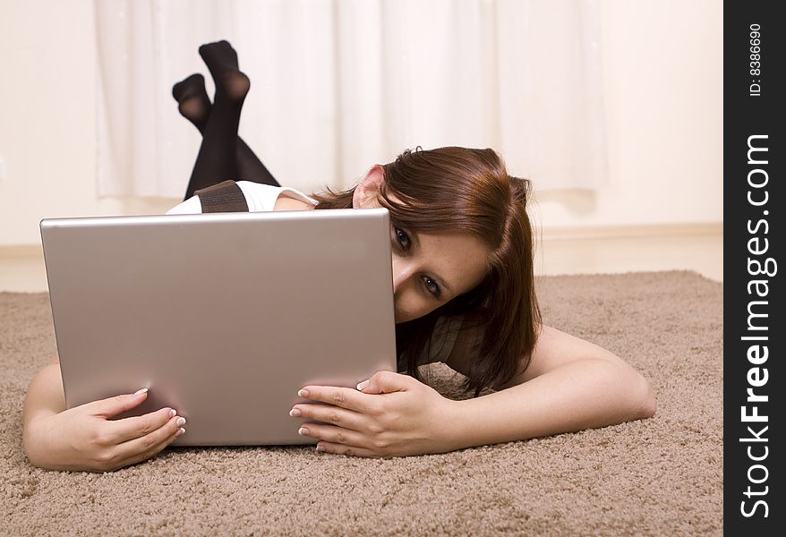 Woman with laptop on carpet