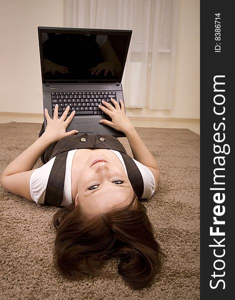 Woman with laptop on carpet