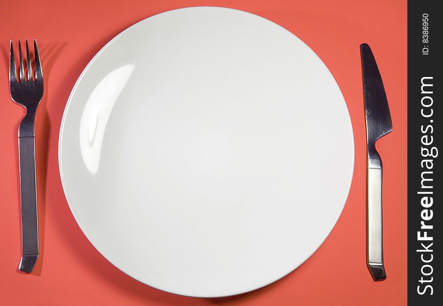 Single plate against red background. Single plate against red background