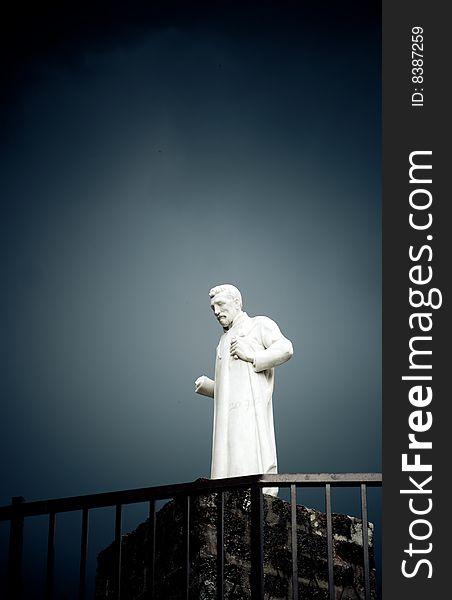 Lonely white thinker sculpture against cloudy sky