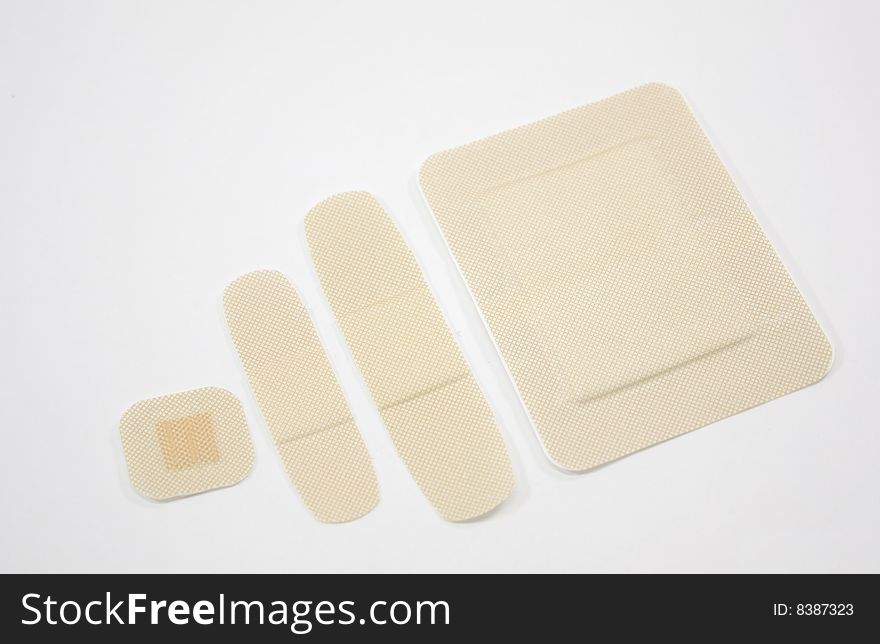 Fours sizes of bandages isolated on a white background. Fours sizes of bandages isolated on a white background.