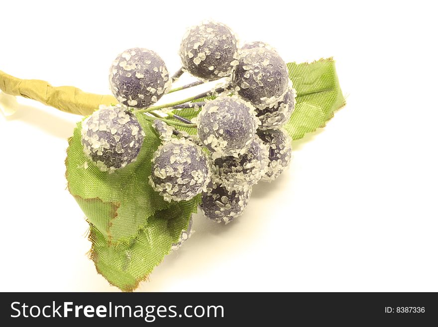 Purple berries and leaves isolated on a white background.