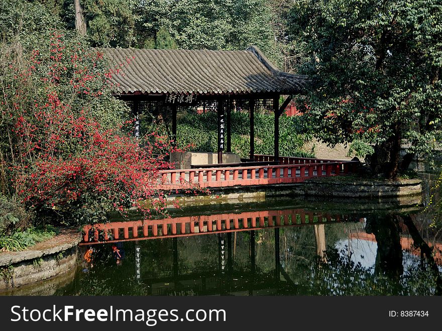 Lakeside viewing and resting pavilion with orange Quince flowers at Wang Cong Ci Park - Xu Lei Photo / Lee Snider Photo Images. Lakeside viewing and resting pavilion with orange Quince flowers at Wang Cong Ci Park - Xu Lei Photo / Lee Snider Photo Images.