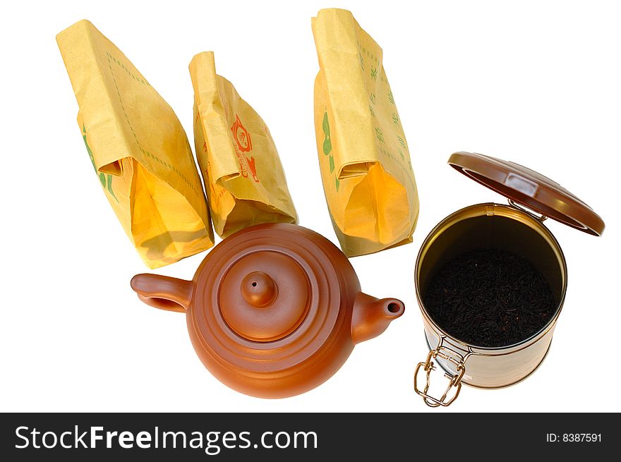 Chinese pottery (clay) teapot, tea in paper bags and tin on isolated background. Chinese pottery (clay) teapot, tea in paper bags and tin on isolated background.