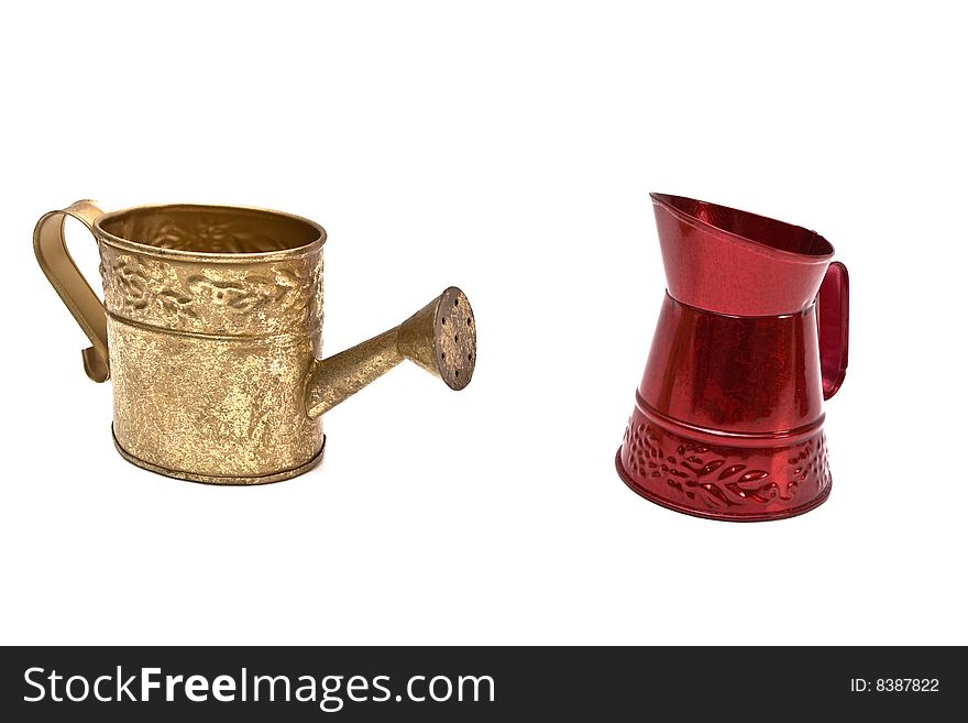 Two small metal watering cans on white background. Two small metal watering cans on white background.