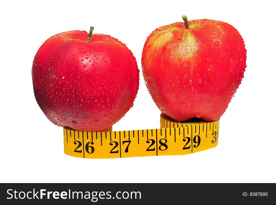 Depicted are two red apples on the measuring tape - isolated over white. Depicted are two red apples on the measuring tape - isolated over white