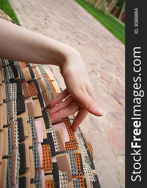 Woman touching a bench composed of rubber plates. Woman touching a bench composed of rubber plates