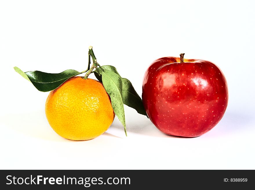 Red apple with orange mandarin isolated on whitebackground. Red apple with orange mandarin isolated on whitebackground