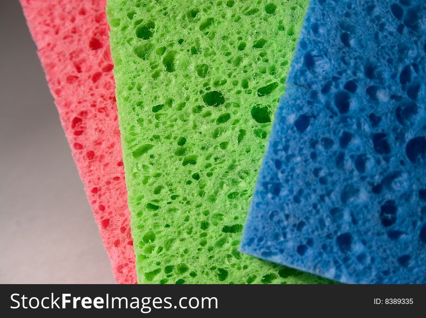 Close-up of multicolor sponges for cleaning. Can be used as a background and to focus on the sponge structure. Close-up of multicolor sponges for cleaning. Can be used as a background and to focus on the sponge structure