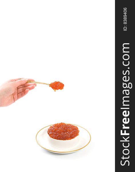 The waitress holds in hands a spoon with red caviar isolated on white. The waitress holds in hands a spoon with red caviar isolated on white
