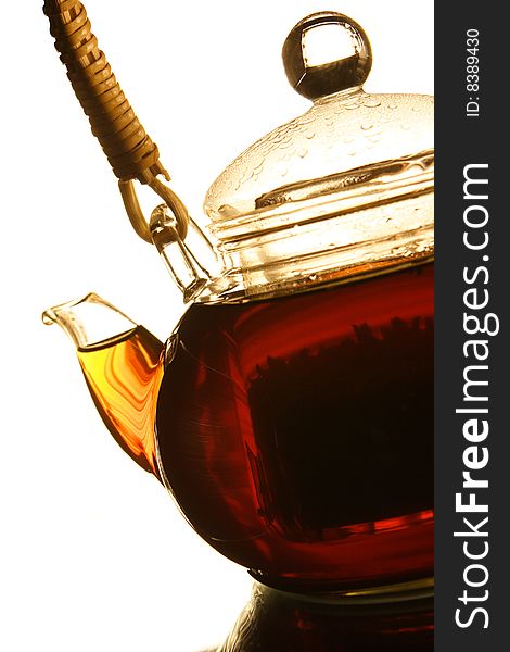 Teapot with fresh tea on white background