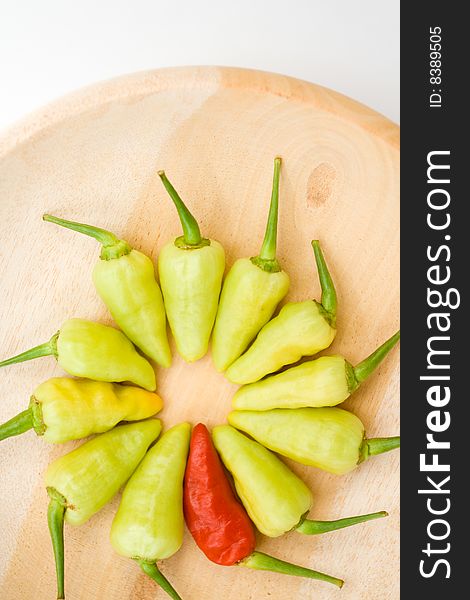 Arrangement of red and yellow chili on wooden plate. Arrangement of red and yellow chili on wooden plate