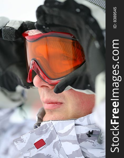 Snowboarder looking in goggles