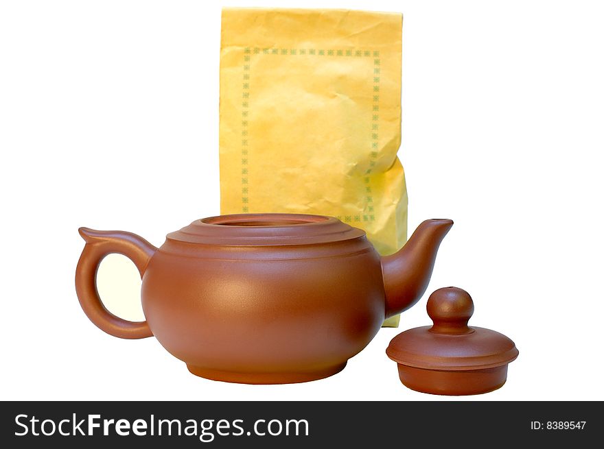 Chinese pottery (clay) teapot and tea in paper bags on isolated background. Chinese pottery (clay) teapot and tea in paper bags on isolated background.