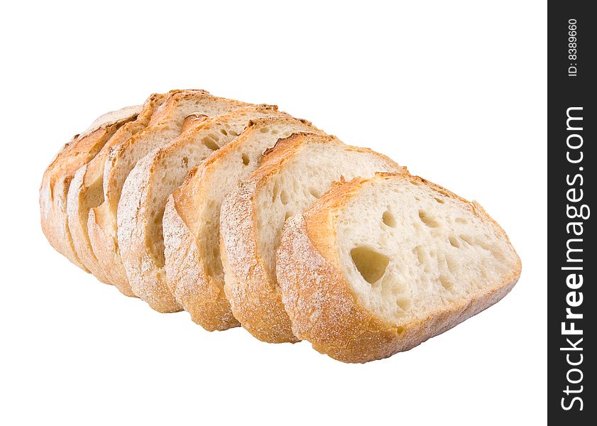 Fresh village bread cut on slices isolated at the white background