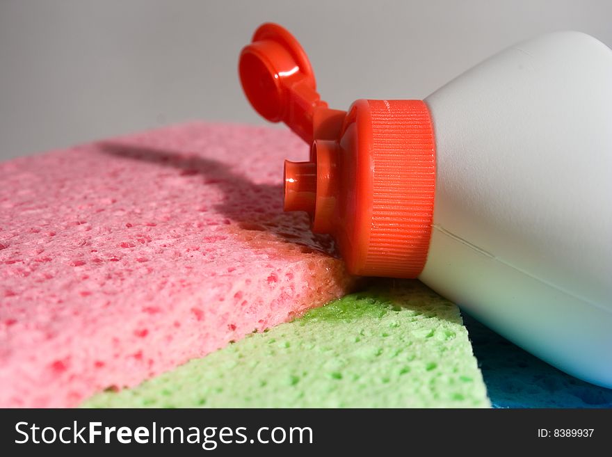 Empty bottle with washing liquid. Multicolor sponges. Empty bottle with washing liquid. Multicolor sponges.