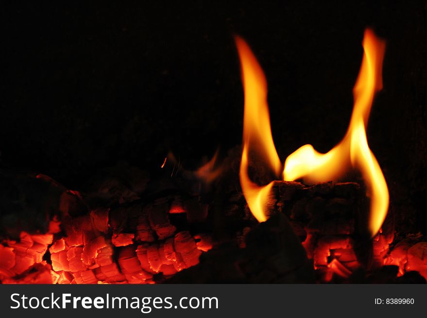 Flames of fire in the fireplace. Flames of fire in the fireplace