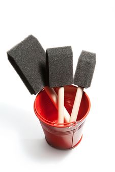 Shiny Red Bucket Contains Paint Brushes. Stock Photography