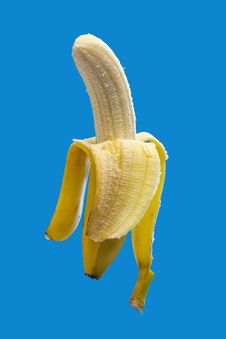 Banana On Blue, Half Peeled Stock Photo Banana On Blue, Half Peeled Stock Photo