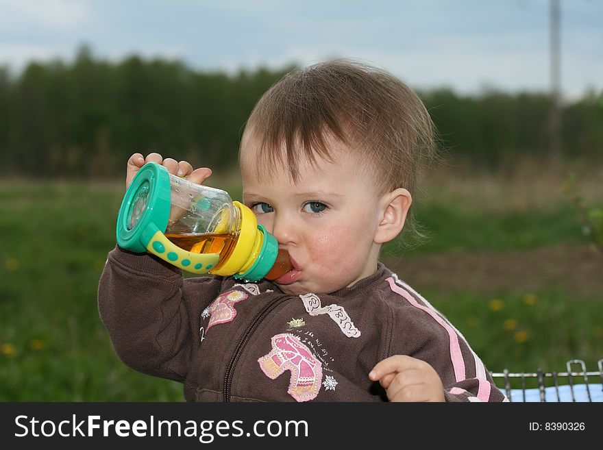 Child drinks juice from a vial. Child drinks juice from a vial