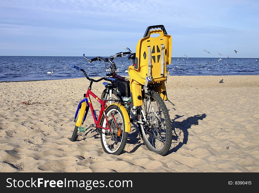 Two standing bicycles on the beach. Two standing bicycles on the beach