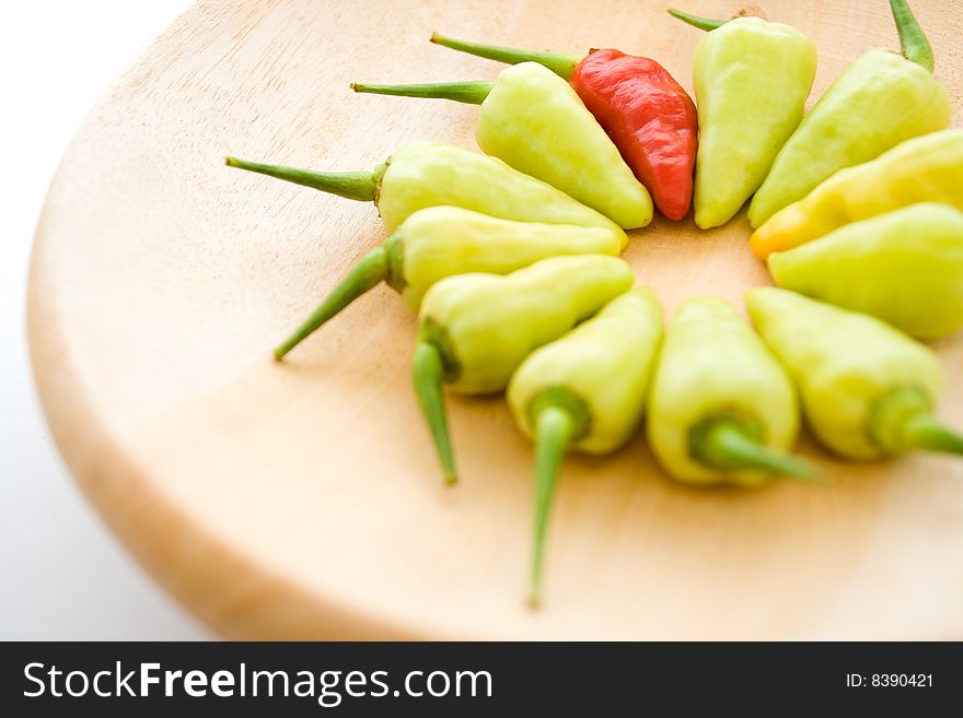 Arrangement of red and yellow chili on a pestle plate. Arrangement of red and yellow chili on a pestle plate