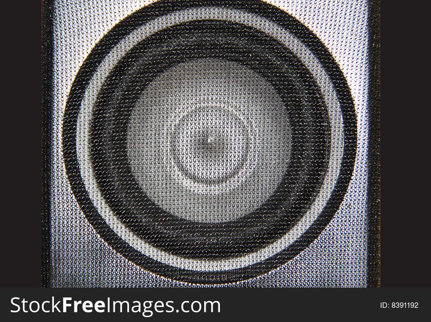 Subwoofer / speaker shot up close, showing detail of mesh covering the speaker and cone. Subwoofer / speaker shot up close, showing detail of mesh covering the speaker and cone