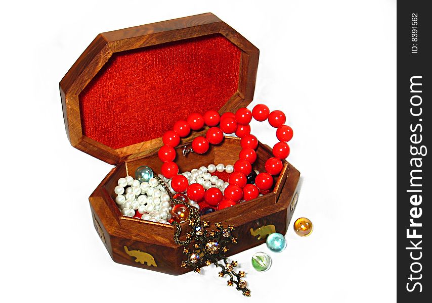 Wooden box with jewelry copper cross, coral beads, beads made of quartz