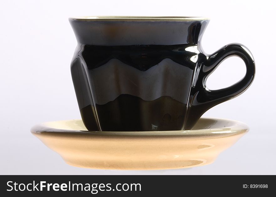 Black coffee cup with a saucer isolated on a white background. Black coffee cup with a saucer isolated on a white background