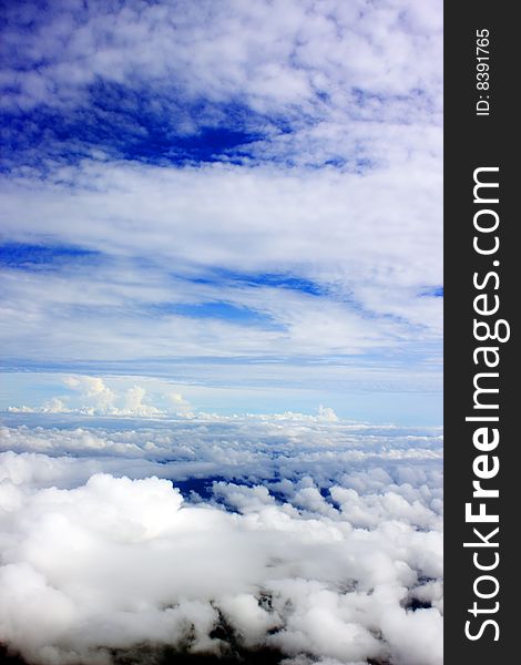 Aerial view of cloudy blue sky from aircraft window. Aerial view of cloudy blue sky from aircraft window.