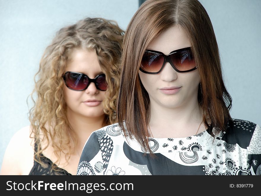 Two girls wearing glasses trying to make some concept like Men in Black