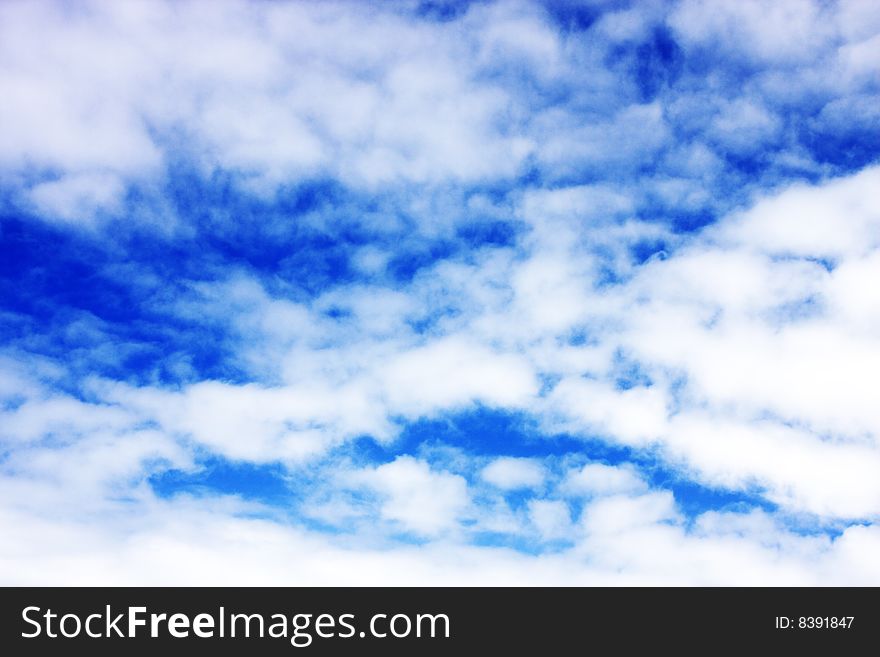 Aerial view of cloudy blue sky from aircraft window. Aerial view of cloudy blue sky from aircraft window.