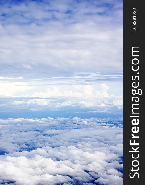 Aerial view of cloudy blue sky from aircraft window. Aerial view of cloudy blue sky from aircraft window.