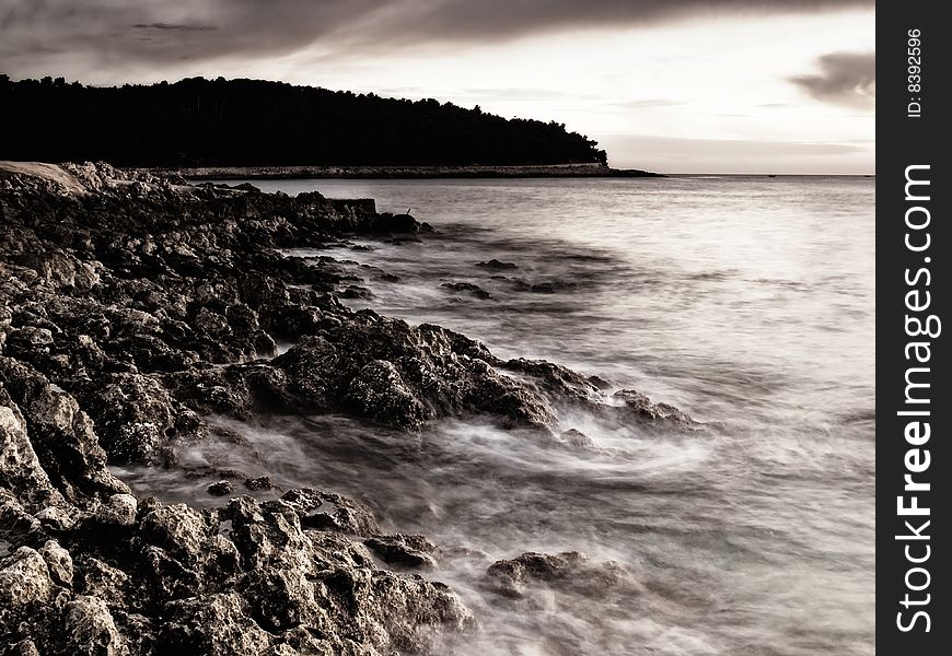 Sunset on the beach.Rocky Adriatic coast on the island Losinj, Croatia. This portfolio contains color version of this image. Sunset on the beach.Rocky Adriatic coast on the island Losinj, Croatia. This portfolio contains color version of this image.