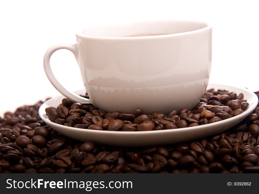 Close-up Of A Cup Of Hot Coffee And Beans